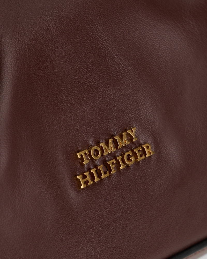 Close-up of smooth brown leather and subtle Tommy branding