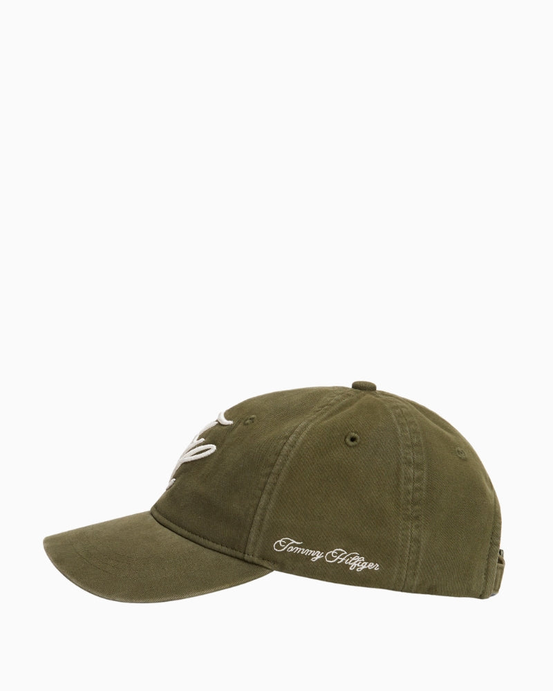 Side view of green baseball cap showing curved brim