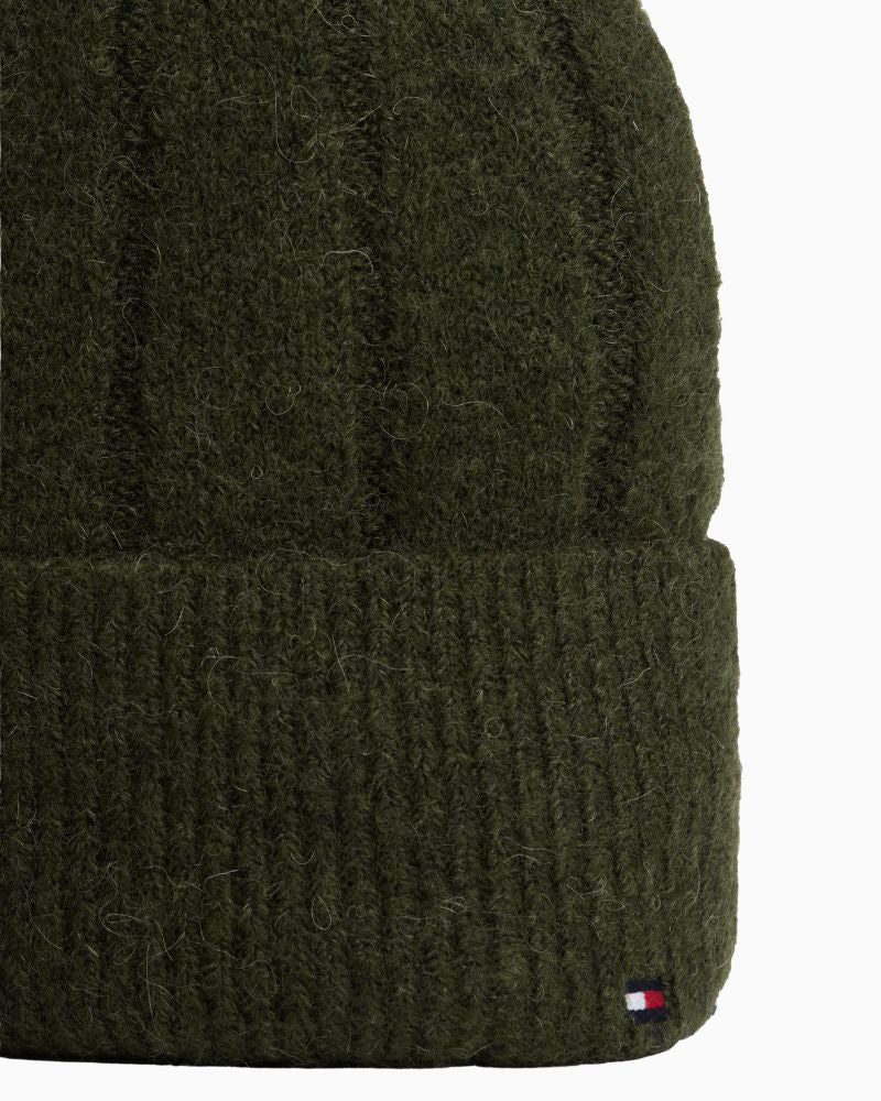 Close up view of green Tommy beanie showing soft alpaca-blend knit and fold-over design