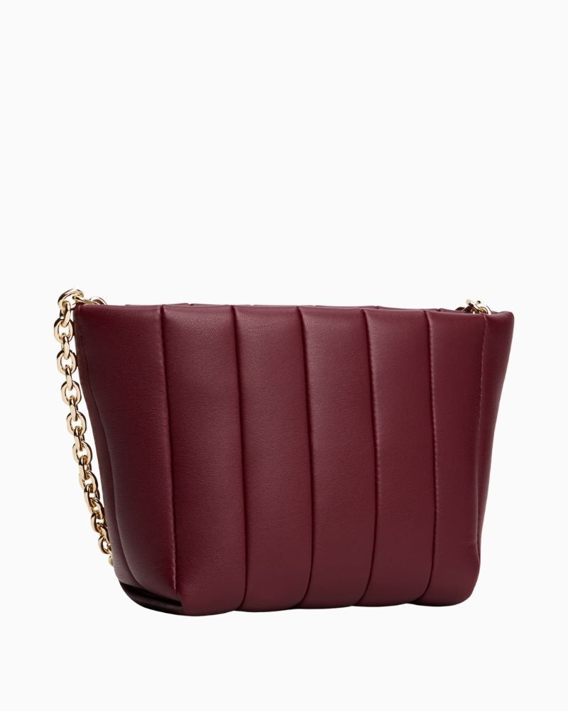 Back of Tommy Hilfiger rouge red mini crossover bag with zip closure and adjustable strap