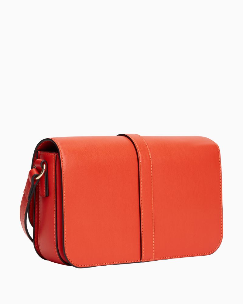 Back view of Tommy flap bag in orange faux leather with gold logo detail