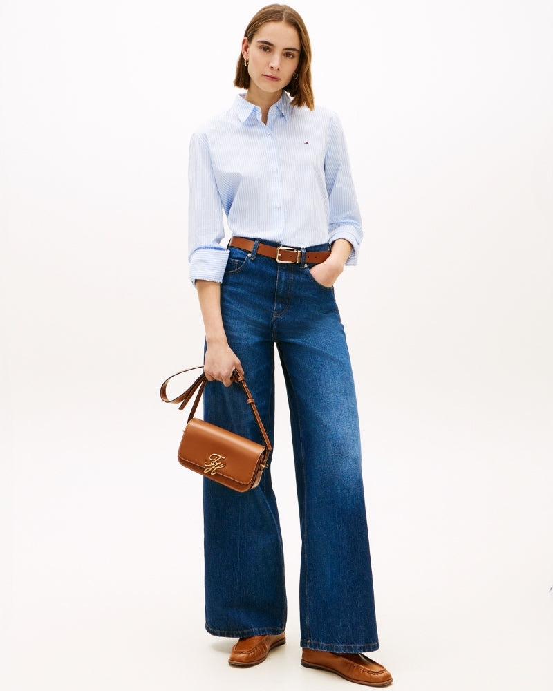 Woman wearing Tommy Hilfiger TH Script flap crossover tan – Áines Boutique