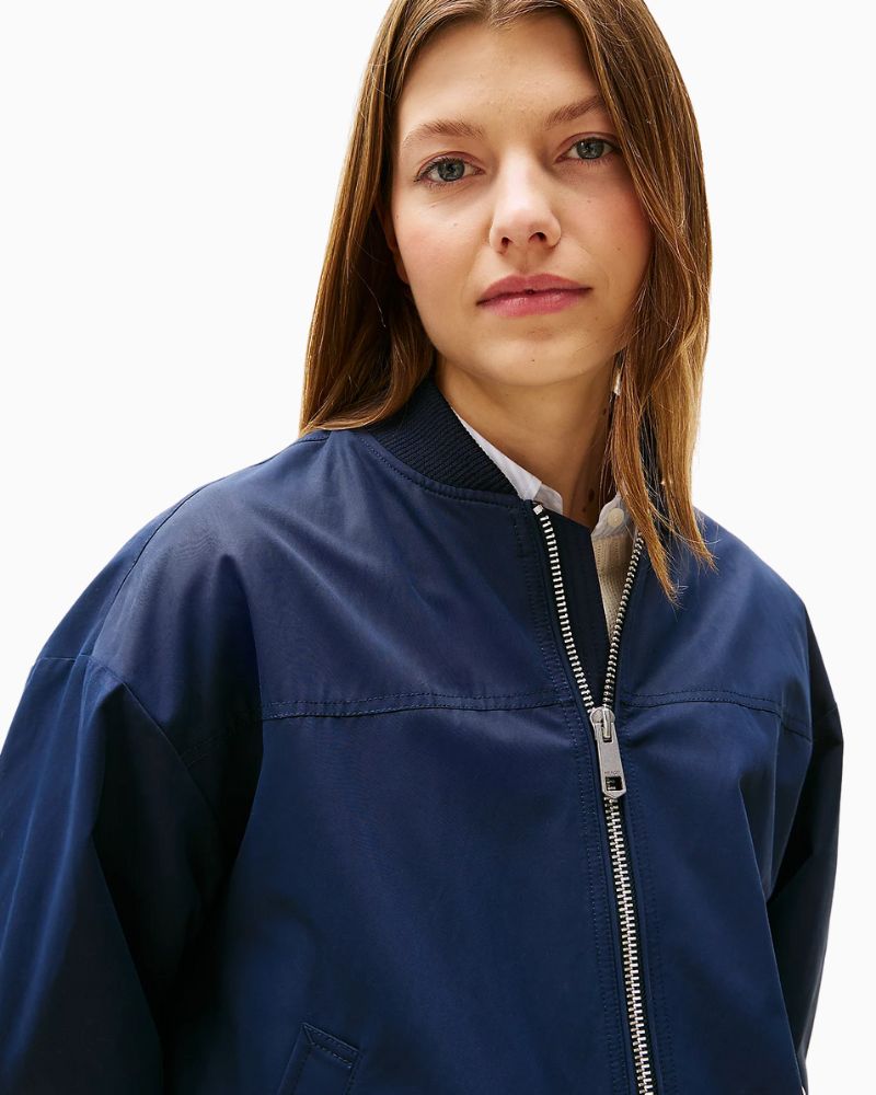 Close-up of Tommy Hilfiger flag embroidery and branded snap-button pocket