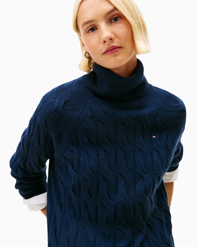 Close-up of roll neck and cable detailing on wool jumper