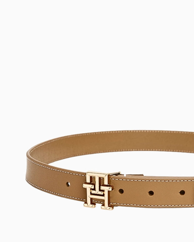 Full circular view of tan leather belt with gold monogram buckle