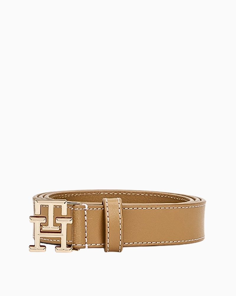 Rolled view of tan belt featuring structured shape and gold ‘TH’ logo buckle