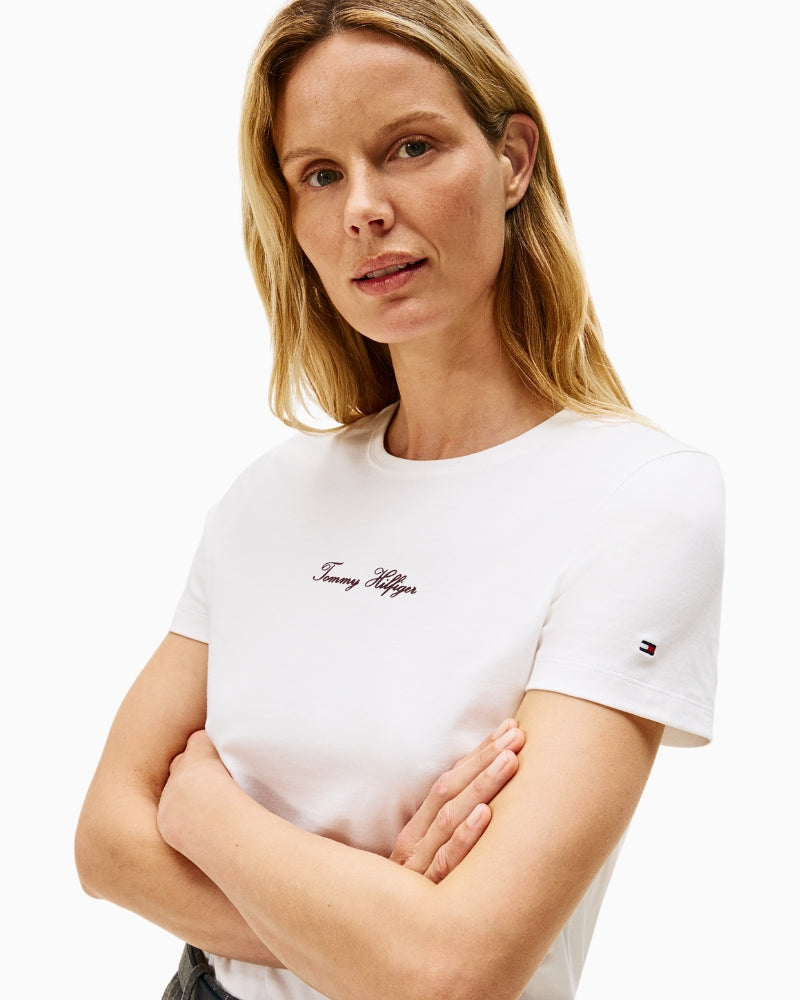 Close-up of cotton fabric and embroidered script logo on chest