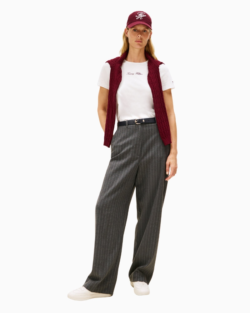 Model wearing Script tee paired with trousers and red vest