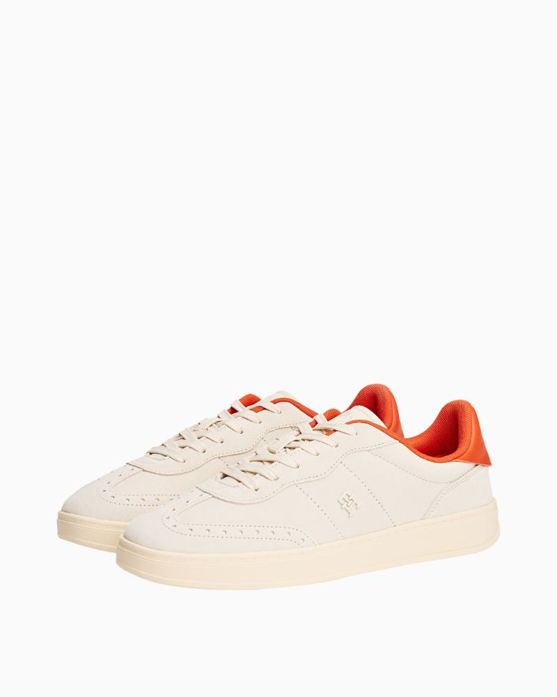 Side view of beige TH Heritage sneakers with classic lace-up design