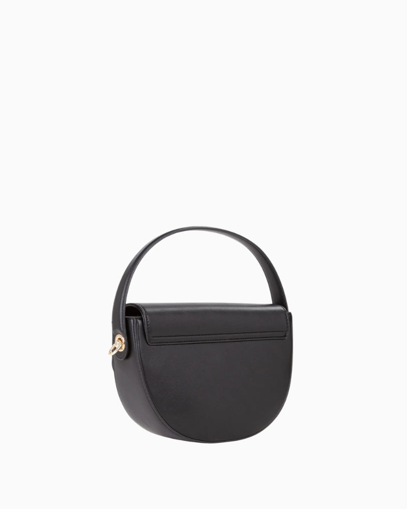 Side view of compact faux leather handbag in classic shape