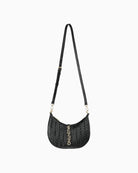Top handle detail on Valentino black hobo showing gold-tone rings and soft drop design