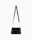 Back view of black Valentino flap bag with smooth faux leather and clean finish