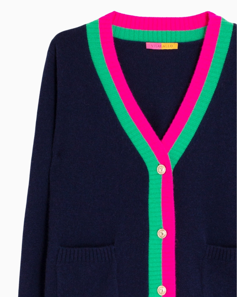 Close-up of fuchsia and green trim with gold buttons on Vilagallo Alina cardigan