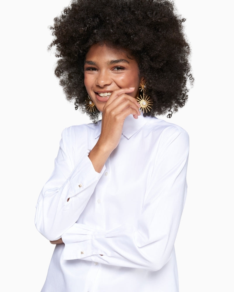 Detail view of double cuff with ruffle finish and metallic button