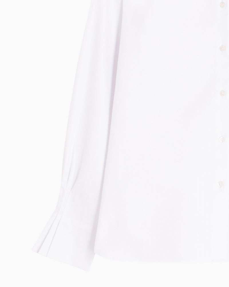 Detail view of double cuff with ruffle finish and metallic button