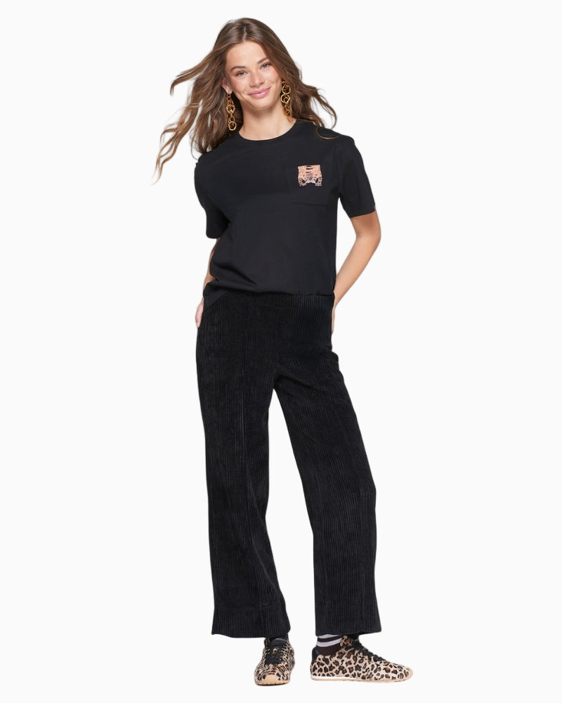 Styled shot with corduroy trousers paired with top showing neat, structured fit