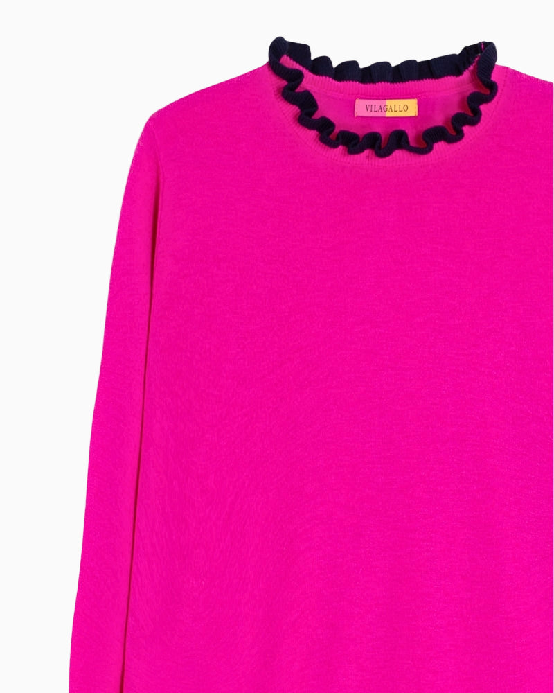 Close-up of navy ruffle detail on cuff and neckline