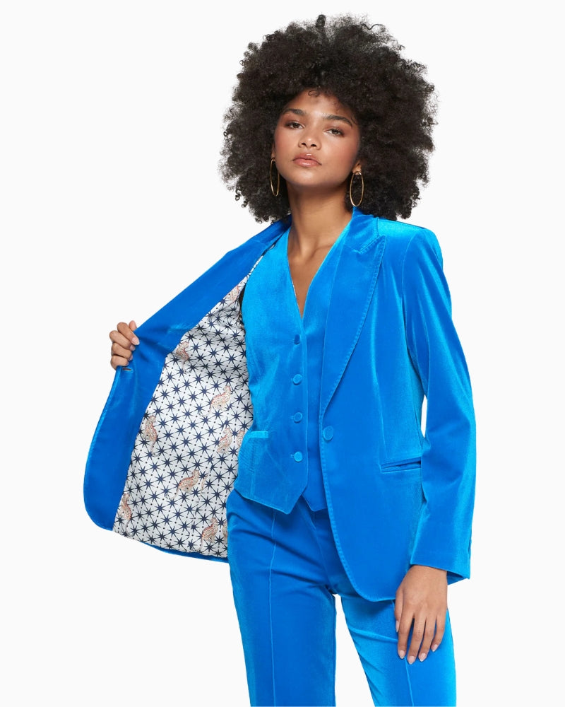 Model wearing blazer showing rich blue velvet fabric highlighting luxe detail