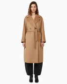 Resina belted wool coat styled over a winter outfit for a polished look