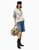 Full view of boxy knit vest showing ribbed hem and relaxed fit