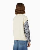 Back view of boxy knit vest showing ribbed hem and relaxed fit