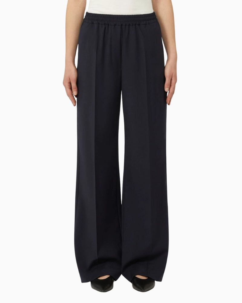 Woman wearing Weekend Max Mara wool trousers navy, front view – Áines Boutique