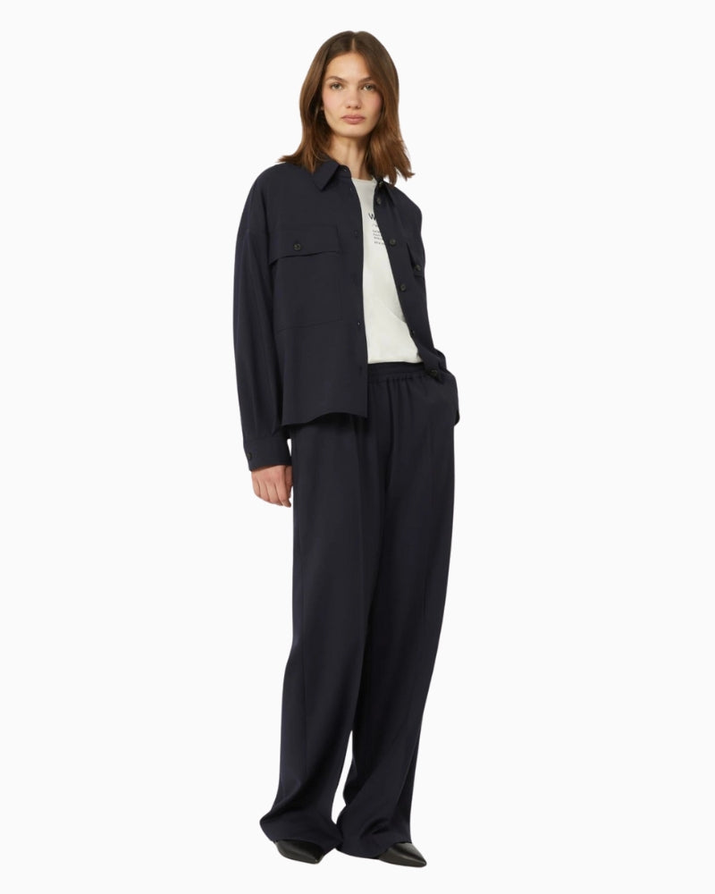 Woman wearing Weekend Max Mara wool trousers navy, side view – Áines Boutique
