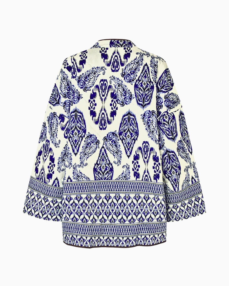 Close-up of floral paisley pattern in soft brights on black base