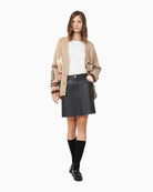 Outfit styled with printed blazer over cream stretch top
