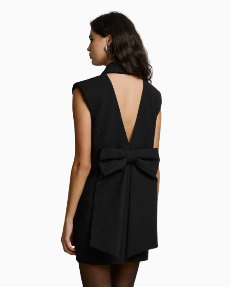 Back view of black mini blazer dress with V-cut and bow detail