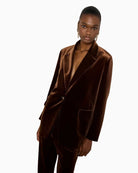 Close-up of flap pockets and button front on rich velvet fabric