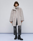 Model styling coat with formal trousers and heels