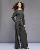 Model wearing rhinestone knit with wide-leg trousers for a casual chic look