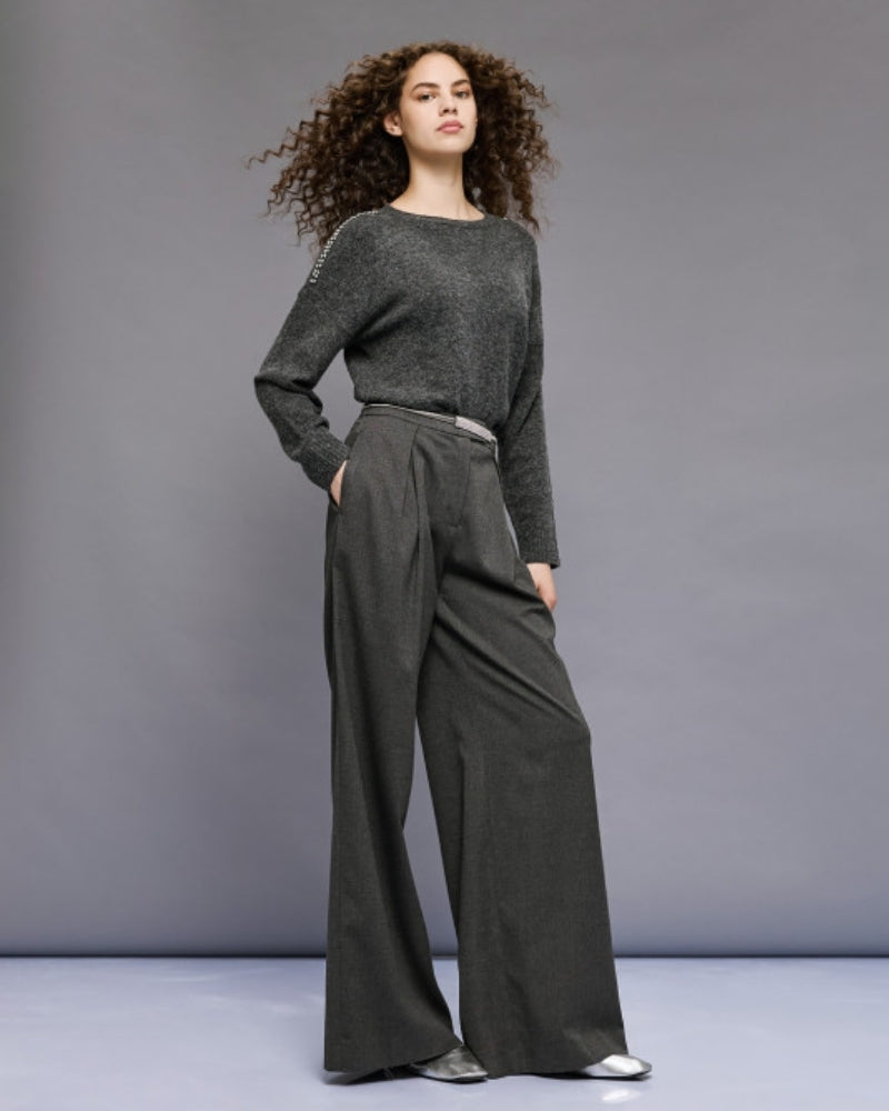 Model wearing rhinestone knit with wide-leg trousers for a casual chic look