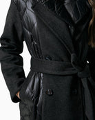 Close-up of quilted fabric and textured finish on black winter coat