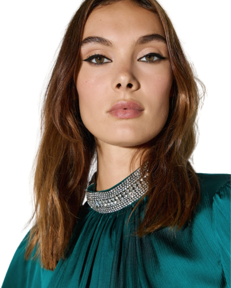 Close-up of rhinestone trim on high neckline