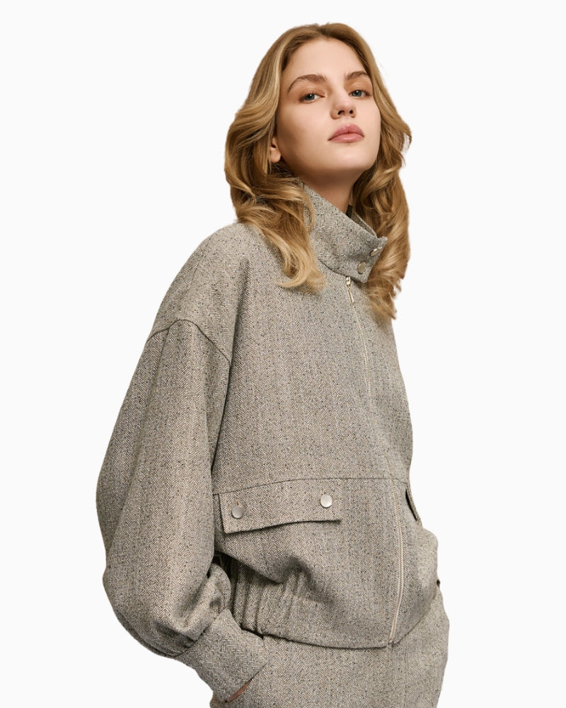 High neck grey jacket — side view showing elastic hem and sleeve detail