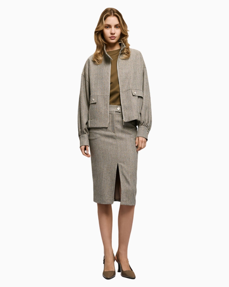 Full look with model wearing grey herringbone jacket by Access and matching skirt