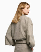 Back view of access grey herringbone jacket with relaxed fit and lined finish