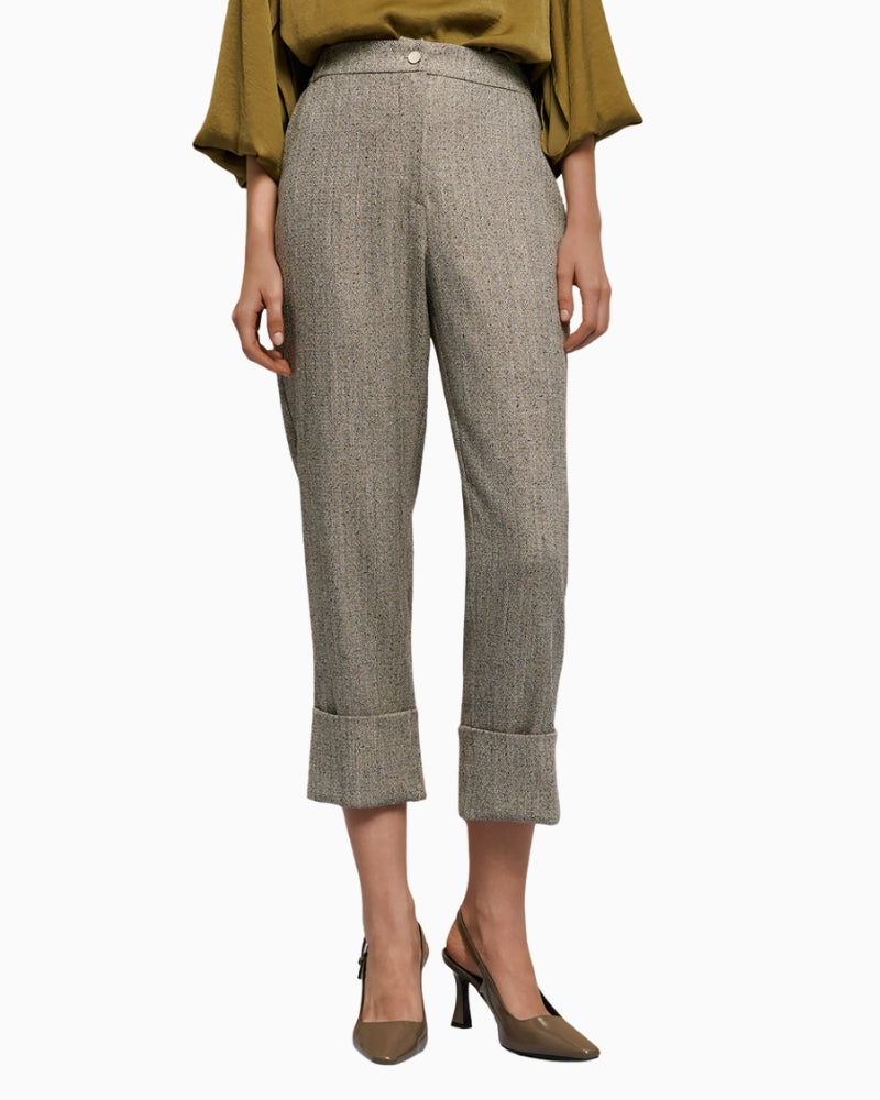 Front view of grey herringbone trousers with turn-up hems and side pockets