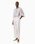 Side view of Access Silver Blouse showing shimmery embossed fabric and relaxed fit