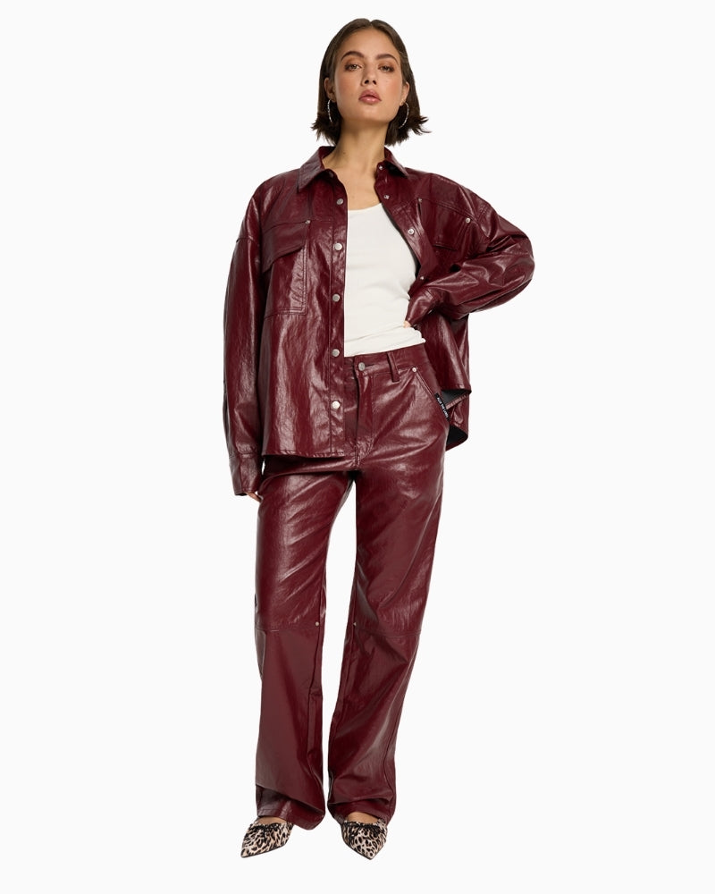 Full front view of Bordeaux faux leather pants with fly zipper and five pocket style