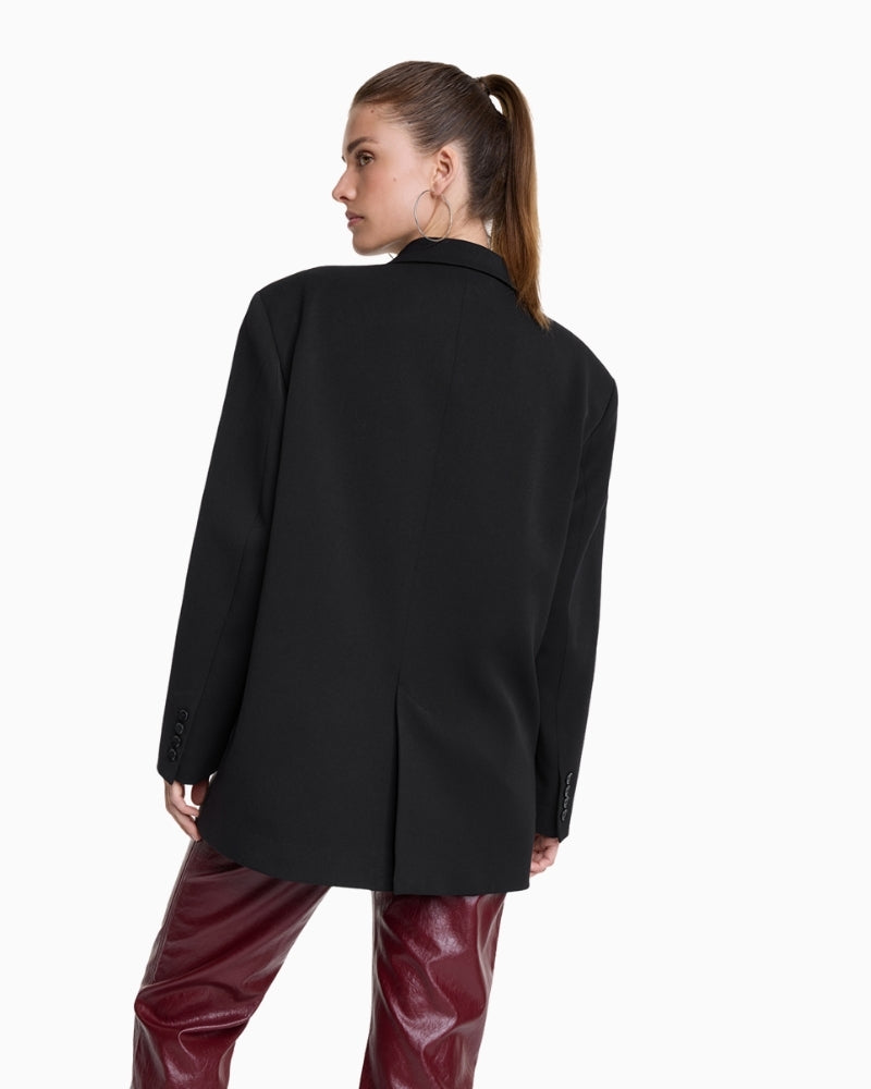 Back view of black grandad blazer with shoulder pads and button cuffs