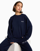 Alix The Label navy scuba sweater with chest logo and round neckline