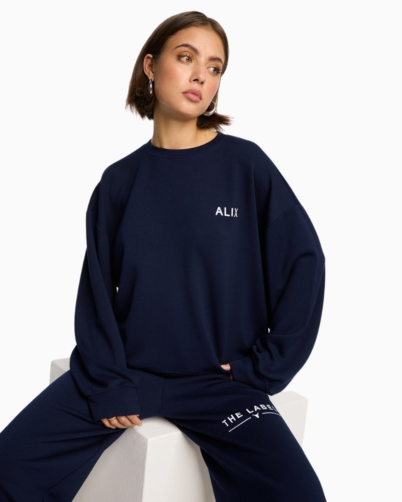 Alix The Label navy scuba sweater with chest logo and round neckline