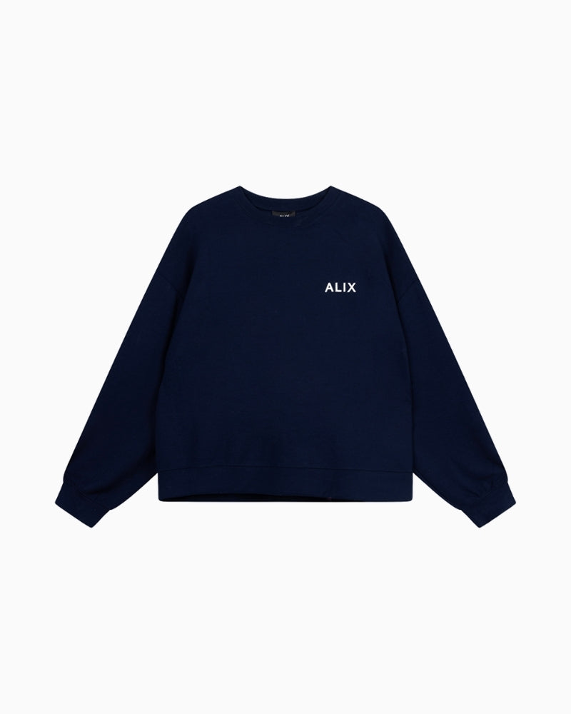 Front view of Alix relaxed navy scuba jersey sweater with long sleeves