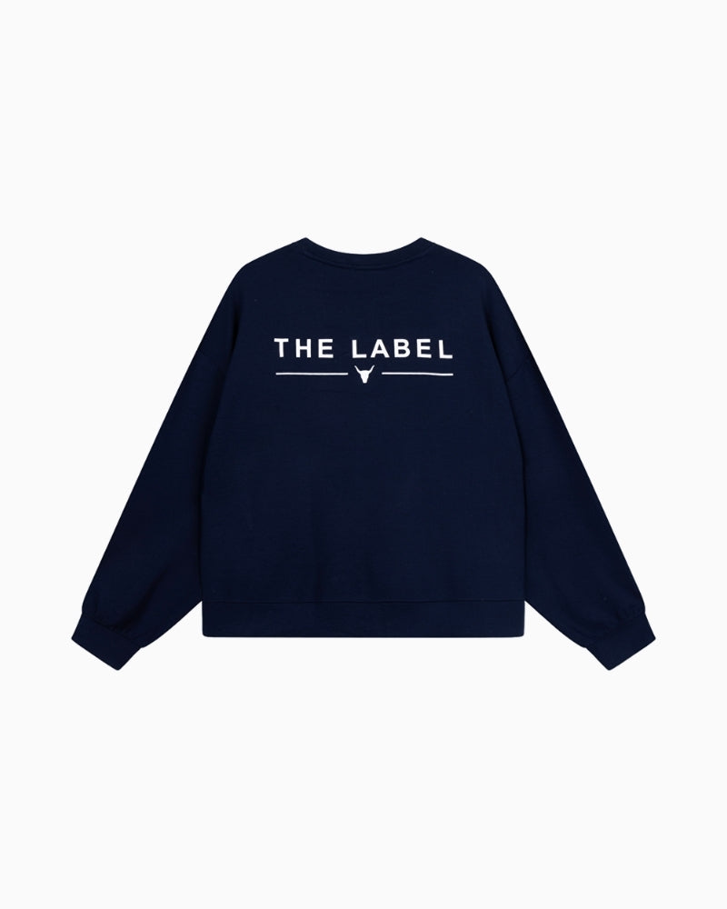 Back view of Alix navy sweater showing bold THE LABEL artwork print