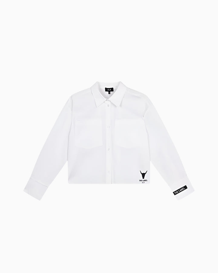 Flat lay front view of white cropped blouse with chest pockets and branded cuffs