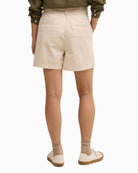 Barbour Fern pleated shorts beige, woman wearing back view – Áines Boutique