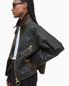 Side profile of Barbour Arlene waxed jacket showing cropped fit and long sleeves